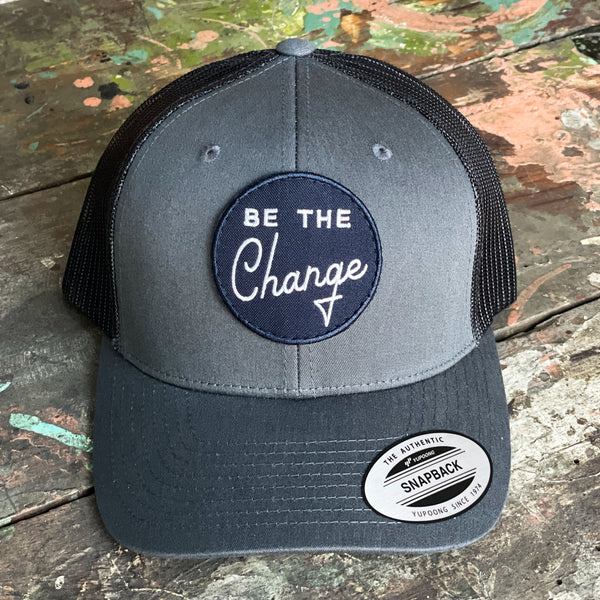 be the change trucker style hat. Navy blue on grey baseball hat