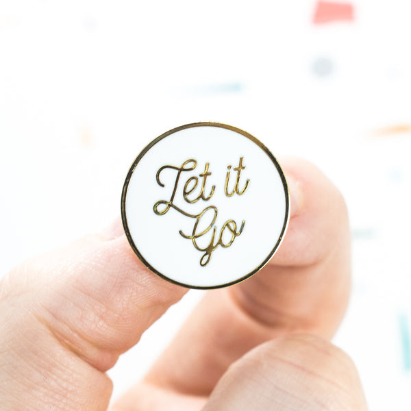 let it go mindful hard enamel pin in gold and white