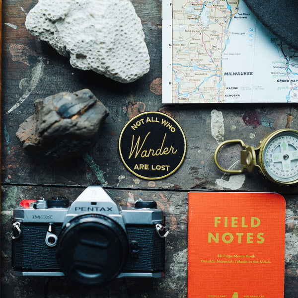 Not all who wander are lost iron on patch with Pentax camera Field Notes book, compass and rocks