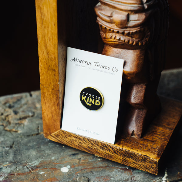 choose kind soft enamel pin promoting kindness and anti-bullying next to wooden statue