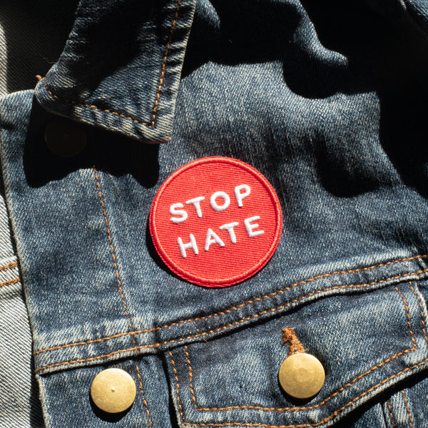 Stop hate inspirational embroidered patch on a jean jacket