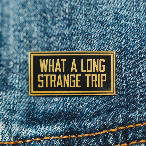 Grateful Dead Pin that says What a Long Strange Trip in gold. Perfect for the hippie or deadhead in your life.