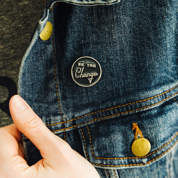 Be the change enamel pin on women's jean jacket