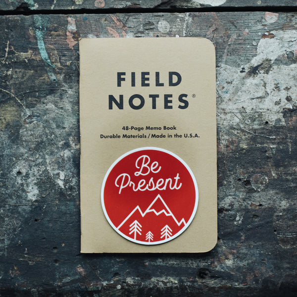 mindfulness sticker be present meditation sticker in red and white on a field notes journal